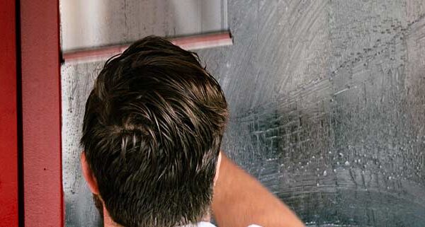 Man Cleaning Window-with Squeegee
